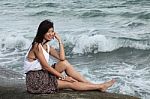 Girl Sitting Near The Sea Stock Photo