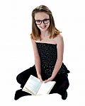 Girl Sitting With Opened Book Stock Photo