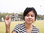 Girl Trying Her Glasses And Checking Out Their Dirtiness Stock Photo