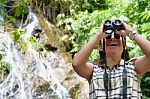 Girl Using Binoculars In Forest Stock Photo