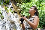 Girl Using Binoculars In Forest Stock Photo