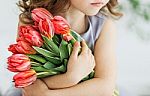 Girl With A Bouquet Of Tulips Stock Photo