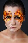 Girl With Orange And Red Rhinestones On Her Face Stock Photo