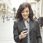 Girl With Smartphone Walking On City Stock Photo