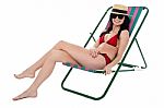 Glamorous Bikini Model Relaxing On Reclining Chair Stock Photo