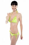 Glamorous Bikini Model Showing Thumbs Up Stock Photo