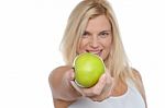 Glamorous Blonde Offering You Juicy Green Apple Stock Photo