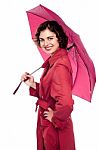 Glamorous Woman Standing Under Pink Umbrella Stock Photo