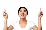 Gorgeous Asian Girl Pointing Upwards Stock Photo