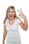 Gorgeous Blonde Girl Gesturing Victory Sign Stock Photo