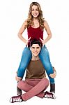 Gorgeous Girl Sitting On Her Boyfriend's Shoulder Stock Photo