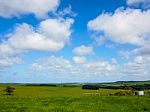 Green Fields And Blue Sky In The Valley Stock Photo