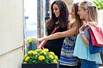 Group Of Beautiful Girls Looking At The Shop Window Stock Photo