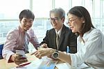 Group Of Business People Meeting With Happiness Emtion Pointing To Smart Phone In Hand Use For Modern Working People Lifestyle On Digital Technology Stock Photo