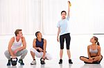 Group Of Diverse People Looking Woman Lifting Kettlebell In Gym Stock Photo