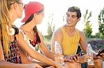 Group Of Friends Texting With Their Smart Phones In The Park Stock Photo