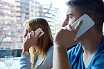 Group Of Friends Using Mobile Phone In Cafe Stock Photo