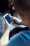 Group Of Friends Using Mobile Phone In Cafe Stock Photo