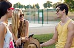 Group Of Friends With Roller Skates And Bike Riding In The Park Stock Photo