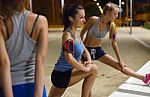 Group Of Girls Doing Stretching At Night Stock Photo