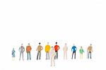 Group Of Miniature People Standing On White Background Stock Photo