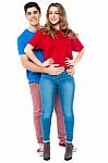 Guy Embracing His Girl From Behind, Arms Around Stock Photo