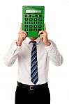 Guy Hiding His Face Behind Big Calculator Stock Photo