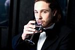 Guy In Tuxedo Drinking Cocktail Stock Photo