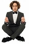 Guy In Tuxedo Striking A Lotus Posture Stock Photo