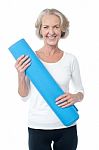 Gym Instructor Holding Blue Exercise Mat Stock Photo