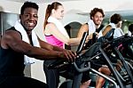 Gym Trainer Exercising Along With His Trainees Stock Photo