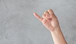 Hand Action Gesture On Grey Background Stock Photo