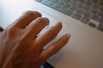 Hand On Laptop Pad Stock Photo