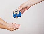 Hands Of Mother Gives The Purse To A Little Girl Stock Photo