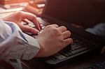 Hands Typing On A Notebook Stock Photo