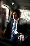 Handsome Business Executive Inside Taxi Cab Stock Photo