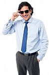 Handsome Businessman Adjusting Sunglasses Stock Photo