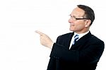 Handsome Businessman Pointing Away Stock Photo