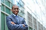 Handsome Businessman With Crossed Arms Stock Photo