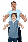 Handsome Father And Son Showing Thumbs Up To Camera Stock Photo