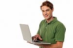 Handsome Guy Operating Laptop Stock Photo