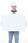 Handsome Male Chef Holding Ad Board Stock Photo