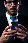 Handsome Stylish Man In Elegant Black Suit Using Mobile Phone Stock Photo