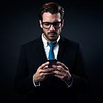 Handsome Stylish Man In Elegant Black Suit Using Mobile Phone Stock Photo