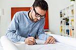 Handsome Young Businessman Working In The Office Stock Photo