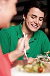 Handsome Young Guy Enjoying Meal In Restaurant Stock Photo