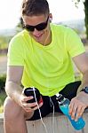 Handsome Young Man Listening To Music After Running Stock Photo