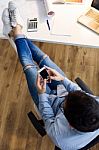 Handsome Young Man Using His Mobile Phone In The Office Stock Photo