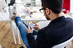 Handsome Young Man Using His Mobile Phone In The Office Stock Photo