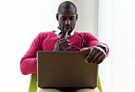 Handsome Young Man Working With His Laptop At Home Stock Photo